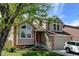 Charming two-story home featuring manicured lawn, brick accents, and beautiful windows for great curb appeal at 8555 Angela Ln, Parker, CO 80134