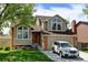 Charming two-story home boasts a well-maintained yard, a driveway with a white car, and beautiful architectural features at 8555 Angela Ln, Parker, CO 80134