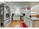 Well-lit kitchen with stainless steel appliances, wooden floors, and marble countertops at 8555 Angela Ln, Parker, CO 80134