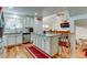 Modern kitchen featuring an island, stainless steel appliances, and wooden floors at 8555 Angela Ln, Parker, CO 80134