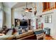 Open-concept living area features hardwood floors, vaulted ceiling, a ceiling fan, and stylish decor at 8555 Angela Ln, Parker, CO 80134