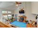 Sunlit living room features a pool table, wood-burning fireplace, and vaulted ceiling at 8555 Angela Ln, Parker, CO 80134