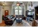 Inviting living room featuring vaulted ceiling, large windows, leather furniture, and stylish decor at 8555 Angela Ln, Parker, CO 80134