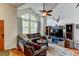 Inviting living room with vaulted ceiling, large windows, leather furniture, and stylish decor at 8555 Angela Ln, Parker, CO 80134