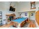 View of open concept living space featuring a pool table and wood-burning fireplace at 8555 Angela Ln, Parker, CO 80134