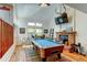 Bright living room with hardwood floors, fireplace, pool table, and natural light at 8555 Angela Ln, Parker, CO 80134