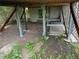 House with posts holding up a raised foundation, along with foliage in the dirt at 882-888 Wolff St, Denver, CO 80204