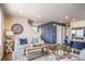 Open-concept living area featuring modern decor, a cozy sofa, and stylish accents with warm neutral paint at 13586 E 103Rd Pl, Commerce City, CO 80022
