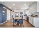 Bright kitchen with white cabinets, stainless steel appliances, and a cozy dining area for enjoyable meals at 13586 E 103Rd Pl, Commerce City, CO 80022