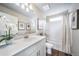 Bathroom features a white vanity, shower with tub and decorative artwork at 13586 E 103Rd Pl, Commerce City, CO 80022