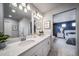 The bathroom has a double sink vanity with modern fixtures, plenty of storage space, and an ensuite bedroom at 13586 E 103Rd Pl, Commerce City, CO 80022