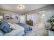 The bedroom has neutral walls, gray carpet, and artwork on the wall, and it connects to the ensuite bath at 13586 E 103Rd Pl, Commerce City, CO 80022