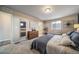 Bright primary bedroom with neutral colors, ensuite bathroom, and carpet floors at 13586 E 103Rd Pl, Commerce City, CO 80022