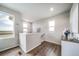 Bright hallway features hardwood floors, natural light, and stylish decor elements at 13586 E 103Rd Pl, Commerce City, CO 80022