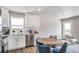 Bright kitchen features modern white cabinetry, stainless steel appliances and wood flooring at 13586 E 103Rd Pl, Commerce City, CO 80022