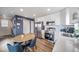 Modern kitchen features stainless steel appliances, white cabinets and an adjacent dining area at 13586 E 103Rd Pl, Commerce City, CO 80022