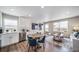 Bright living space featuring a white kitchen, and a cozy living room for relaxing and entertaining at 13586 E 103Rd Pl, Commerce City, CO 80022