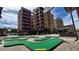 Exterior view of building with mini golf course and mountain backdrop at 555 S Park Ave # 202, Breckenridge, CO 80424