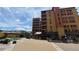 Exterior view of building with mountain backdrop and courtyard at 555 S Park Ave # 202, Breckenridge, CO 80424