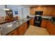 Well-equipped kitchen featuring granite countertops and wood cabinets at 555 S Park Ave # 202, Breckenridge, CO 80424