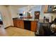 Open kitchen with granite counters, wood cabinets, and black appliances at 555 S Park Ave # 202, Breckenridge, CO 80424