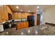 Modern kitchen with wood cabinets, granite counters and black appliances at 555 S Park Ave # 202, Breckenridge, CO 80424