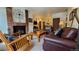 Living room with fireplace, leather sofas, and mountain view at 555 S Park Ave # 202, Breckenridge, CO 80424