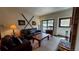 Living room with fireplace, leather furniture, and balcony access at 555 S Park Ave # 202, Breckenridge, CO 80424