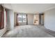 Bright bedroom with neutral walls, plush carpet, and view of bathroom and neighborhood at 2538 Central Park Blvd, Denver, CO 80238