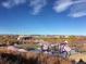 A community park with playground equipment sits beneath a clear blue sky and distant mountains at 2538 Central Park Blvd, Denver, CO 80238