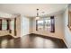 Bright dining room featuring hardwood floors, large windows, and elegant light fixture at 2538 Central Park Blvd, Denver, CO 80238
