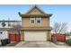 Two-story home featuring an attached garage and a well-maintained front exterior at 2538 Central Park Blvd, Denver, CO 80238
