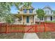 Inviting two-story home with a charming red picket fence and well-maintained front yard landscaping at 2538 Central Park Blvd, Denver, CO 80238