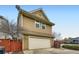 Two-story home featuring an attached garage and a well-maintained front exterior at 2538 Central Park Blvd, Denver, CO 80238