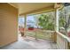 Inviting porch features classic columns and a view of the landscaped front yard with red fence at 2538 Central Park Blvd, Denver, CO 80238
