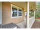Covered front porch featuring classic column supports and hanging flower baskets, adding charm at 2538 Central Park Blvd, Denver, CO 80238