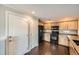 Kitchen featuring wooden cabinets and black appliances, with hardwood floors at 2538 Central Park Blvd, Denver, CO 80238