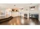 Spacious living area with a fireplace and open layout to the kitchen, featuring hardwood floors at 2538 Central Park Blvd, Denver, CO 80238