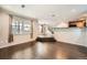Open-concept living room boasts hardwood floors, large windows, and seamless flow to dining and kitchen at 2538 Central Park Blvd, Denver, CO 80238