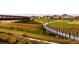 A scenic walking bridge connects green spaces, enhancing community accessibility and outdoor living at 2538 Central Park Blvd, Denver, CO 80238
