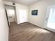 A large bedroom features wood-style flooring, a double closet, and a glass door to the outside at 4451 S Ammons St # 108, Littleton, CO 80123