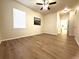 An airy bedroom has wood-style flooring, a ceiling fan, and a large window for natural light at 4451 S Ammons St # 108, Littleton, CO 80123