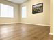A bedroom with ample natural light showcases wood-style flooring and a blank canvas for personalization at 4451 S Ammons St # 108, Littleton, CO 80123