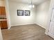 Bright dining area with wood floors, modern lighting, and neutral wall color at 4451 S Ammons St # 108, Littleton, CO 80123