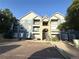 Apartment complex showcasing brick and siding facade, multiple balconies, and ample parking at 4451 S Ammons St # 108, Littleton, CO 80123