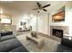 Cozy living room featuring a fireplace, ceiling fan, and view into the dining area at 4451 S Ammons St # 108, Littleton, CO 80123