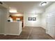 Open living space featuring a kitchen, dining area, wood floors and an entry door at 4451 S Ammons St # 108, Littleton, CO 80123