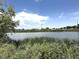 Serene view of the pond surrounded by lush greenery, offering a tranquil escape from urban life at 4451 S Ammons St # 108, Littleton, CO 80123