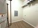 Functional utility room with wood flooring and storage shelf, equipped with essential hookups and service panel at 4451 S Ammons St # 108, Littleton, CO 80123
