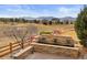 Backyard view showcasing stone waterfall feature, fence, and neighborhood scenery at 5118 Bottlebrush Run, Broomfield, CO 80023